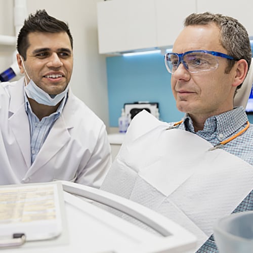 Dentist explaining what's on the screen to patient 