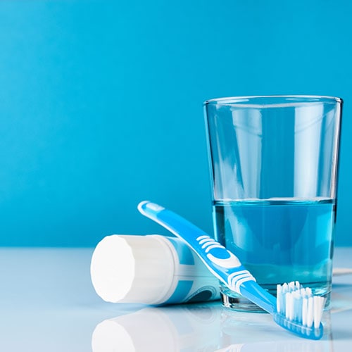 blue toothbrush toothpaste glass mouthwash