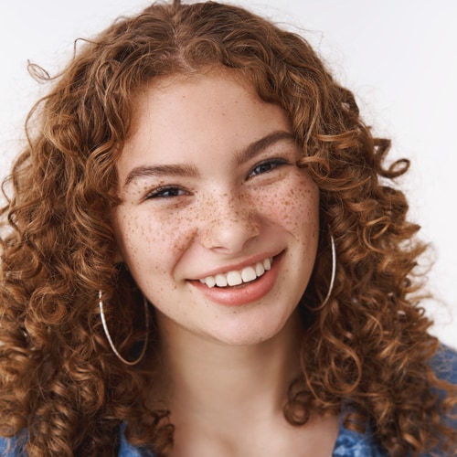 close-carefree-smiling-young-female-student