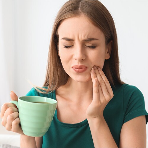 young-woman-sensitive-teeth-cup-hot